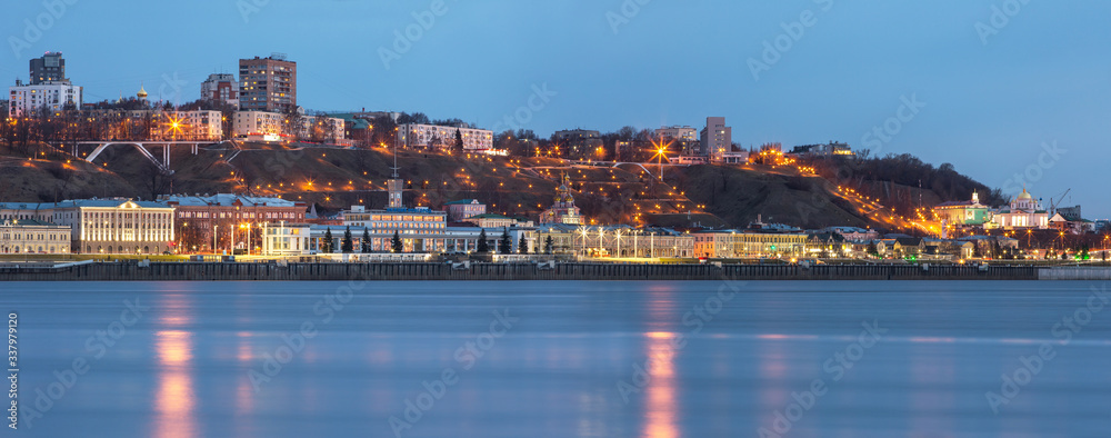 A unique perspective of Nizhny Novgorod in the evening with the city lights on against the backdrop of a beautiful sky and sunset