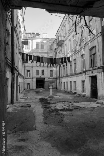 The courtyard of old city have been washed clean clothes and bed linen hanging out to dry between old houses and trees on tight rope. dries clothes on a rope