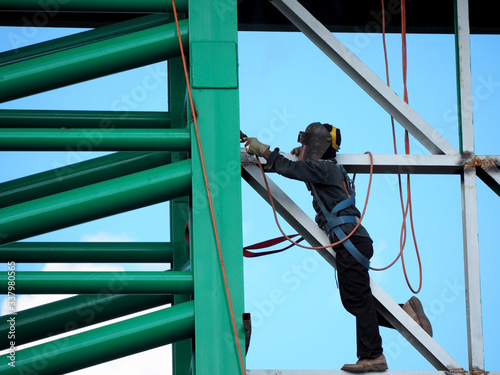 Welding work ,worker with protective welding metal on construction