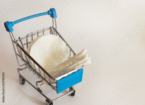 cotton pads and paper cotton buds in a basket
