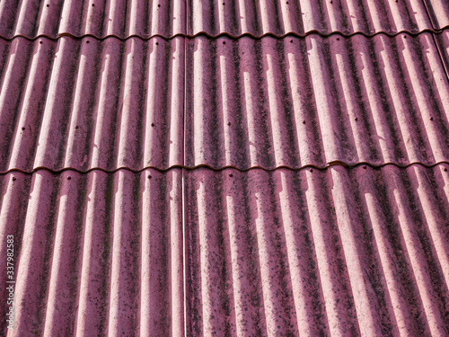 Red asbestos roof top close up shot on a bright sunny day.