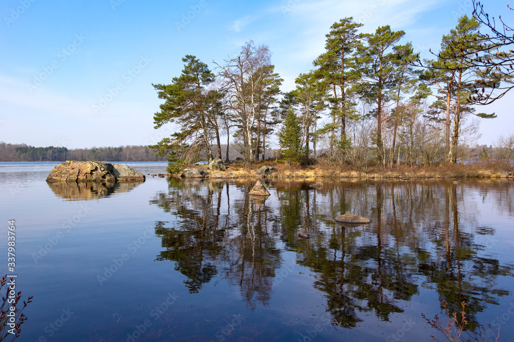 View of a small island, situated in a lake, typical for the south of Sweden