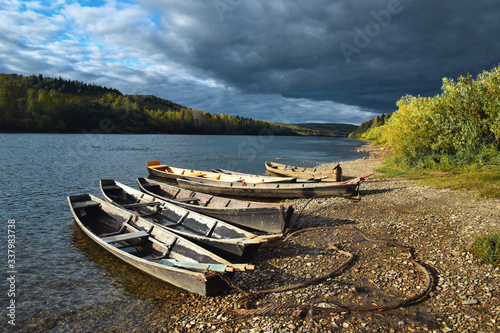 Old wooden boats on the banks of the Vishera River. Ural mountains in Russia