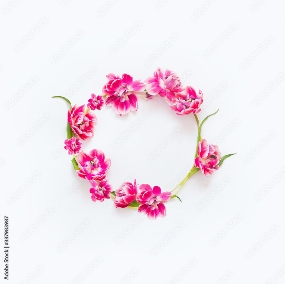 Lovely pink tulips flowers wreath on white desktop background. Top view. Flat lay. Layout. Design. Frame. Springtime composition. Mothers day