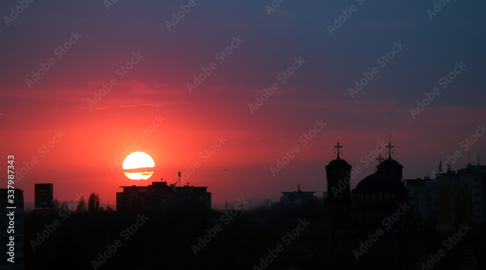 Beautiful sunset above the city skyline , The city of Ploiesti, Romania with a beautiful sun Beautiful sunset above the city skyline , The city of Ploiesti, Romania with a beautiful sun