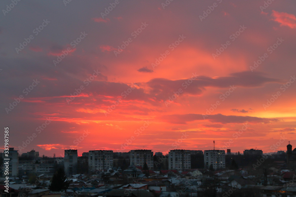 Fototapeta premium Beautiful sunset above the city skyline , The city of Ploiesti, Romania with a beautiful sun