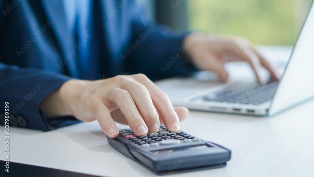 Businessman accountant using calculator and laptop for calculating finance on desk office. business financial accounting concept. Businessman accountant using calculator and laptop for calculating finance on desk office. business financial accounting concept.