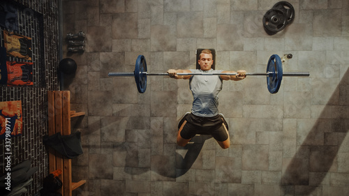 Top View Shot of Professional Athlete Doing Bench Press Workout with a Barbell in the Hardcore Gym. Muscular and Athletic Bodybuilder Doing Barbell Exercise. photo