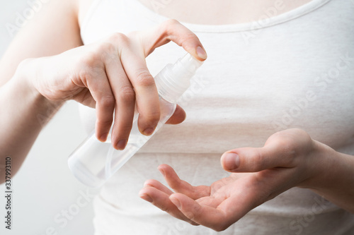 Female hands applying antibacterial liquid soap close up