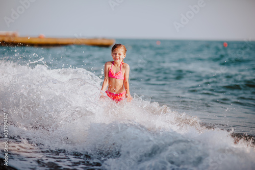 girl jumping on the waves © Alina