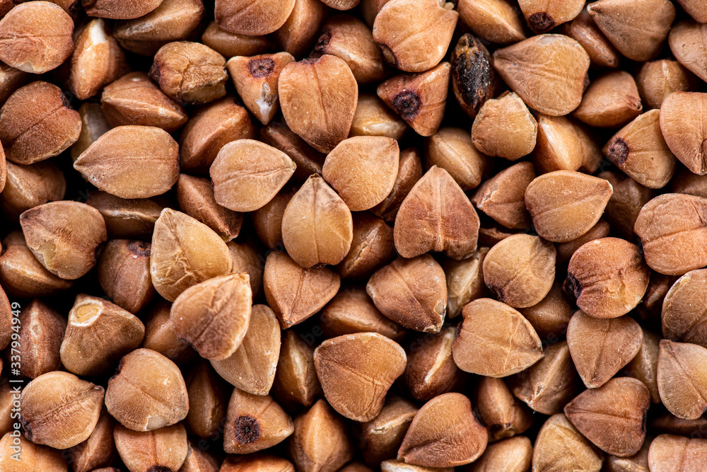 buckwheat brown seeds on a black background top view buckwheat brown seeds on a black background top view