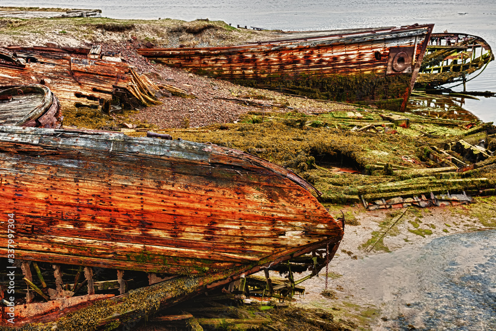 HDR photo. Cemetery of fishing boats in water of the Barents Sea, Teriberka, Russia. HDR photo. Cemetery of fishing boats in water of the Barents Sea, Teriberka, Russia.