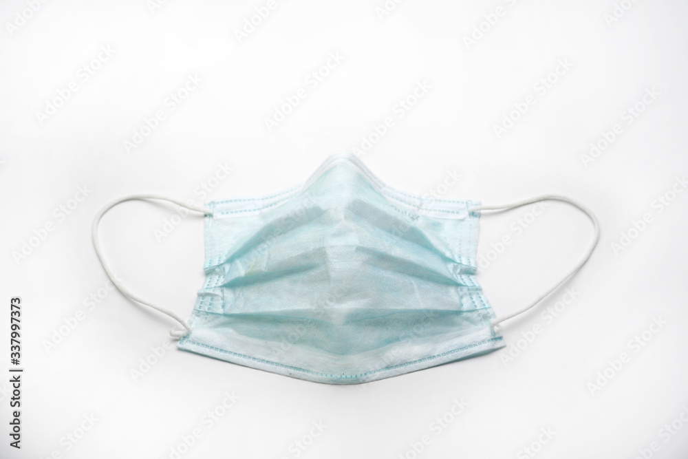 Dirty used medical protective face mask on an isolated white background, preventing coronavirus. Dirty used medical protective face mask on an isolated white background, preventing coronavirus.