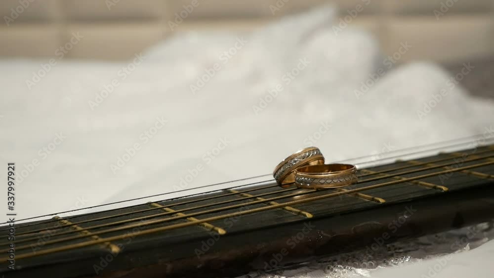 wedding rings on guitar background of white bride dress wedding rings on guitar background of white bride dress