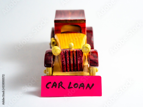 Front close up shot of a vintage four-wheeler with CAR LOAN on pink colored sticky note. photo