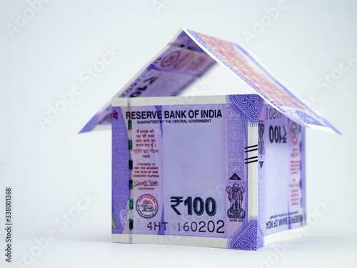 Low angle close-up shot of a home made with money notes showing loan and finance concept.