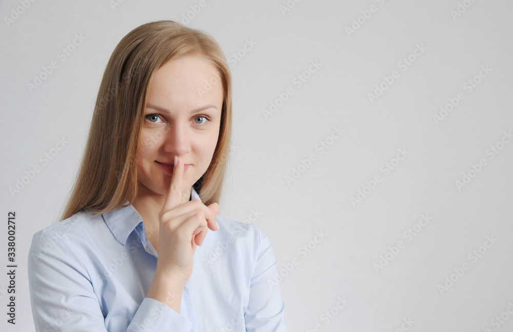 young girl shows hush gesture. be quiet concept young girl shows hush gesture. be quiet concept