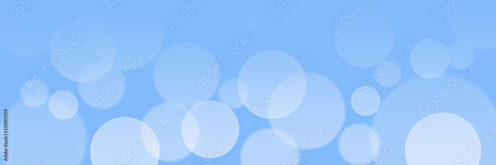 Obraz premium Abstract light blue bokeh banner background - birthday, father's day, valentine's day panorama - blurry bokeh circles on a light blue background. Christmas or spring concept