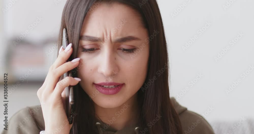 Young woman having quarrel with boyfriend via cellphone Young woman having quarrel with boyfriend via cellphone