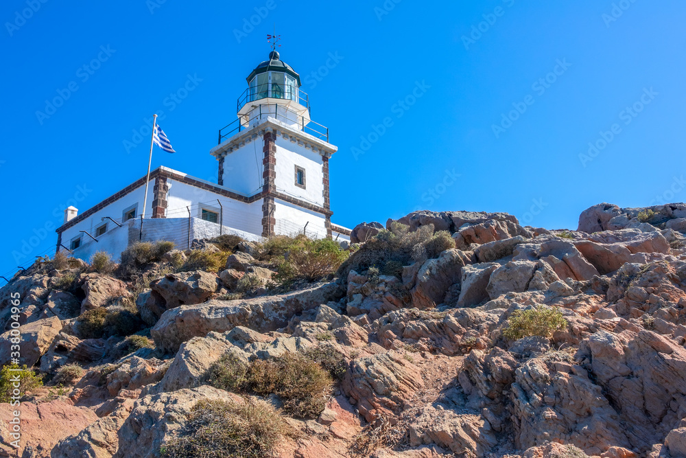 Greek Lighthouse and Flag on a Sunny Cliff