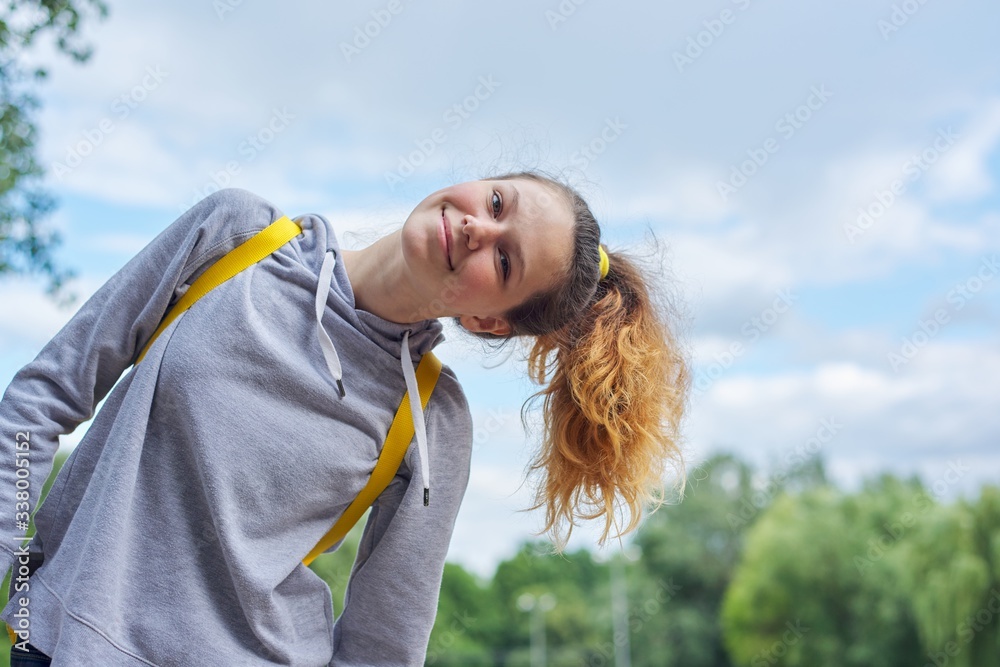 Closeup portrait of teenage girl of 14, 15 years old in gray sweatshirt Closeup portrait of teenage girl of 14, 15 years old in gray sweatshirt