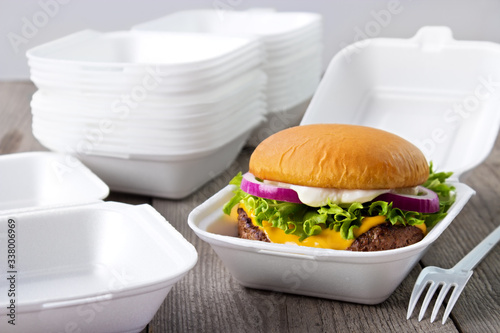 Disposable styrofoam burger boxes with cheeseburger photo