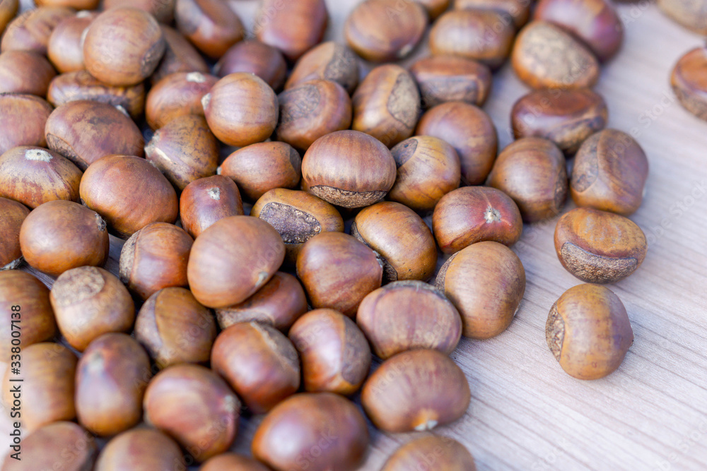 Closeup horse chestnuts on wooden table background, healthy food concept Closeup horse chestnuts on wooden table background, healthy food concept