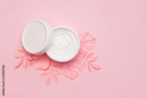 Cosmetics, Moisturizer, Bottle cream with paper leaves on pink background. copy space