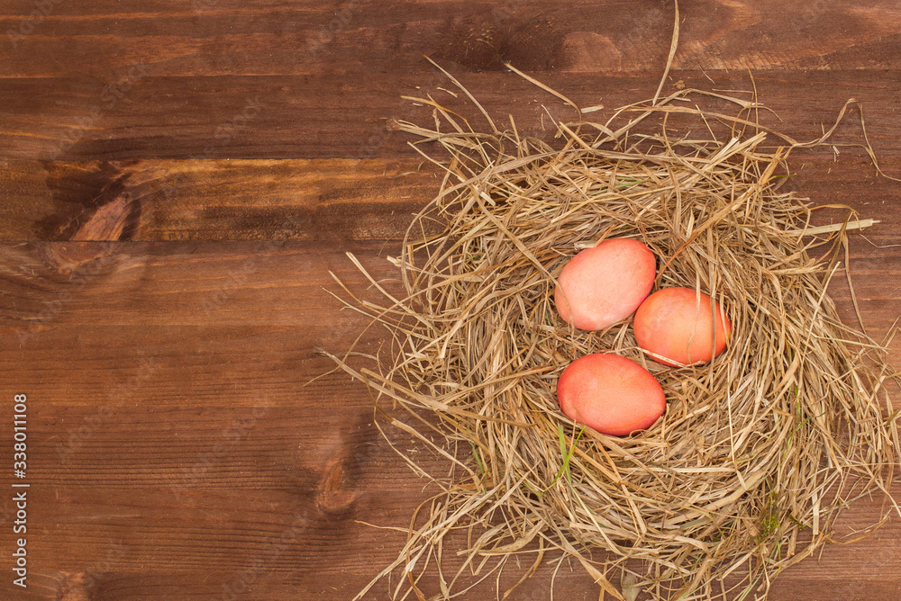 Easter, Easter eggs collection as background.
Easter eggs on a brown wooden table.
Easter eggs and hay. Orange eggs in the nest.