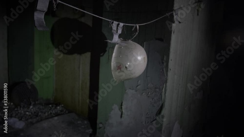 Irradiated Firemen's Helmet in the Basement of the Hospital in Pripiat, Chernobyl. Wide Dolly Shot