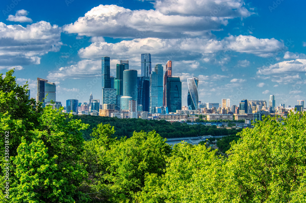 Large panoramic view of Moscow city buildings, a modern business center on the banks of the Moscow river on a bright Sunny day. The view of Moscow state University.