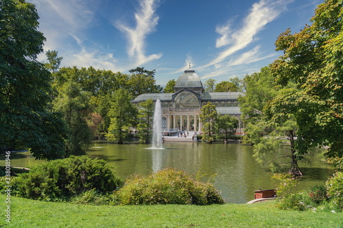 Panoramic of the Crystal Palace in the Retiro Park of Madrid with the cloudy sky