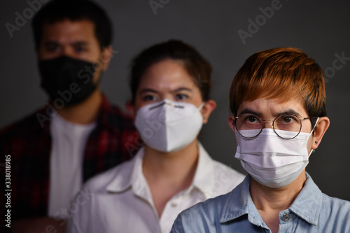 People wearing surgical masks looking worried concerned with pandemic outbreak Coronavirus (covid-19)situation