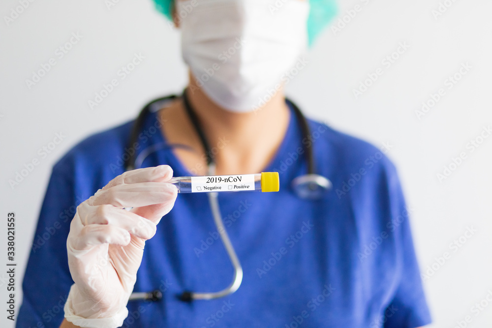 Unidentified doctor with mask to avoid infection, hold a 2019-nCoV test tube Unidentified doctor with mask to avoid infection, hold a 2019-nCoV test tube