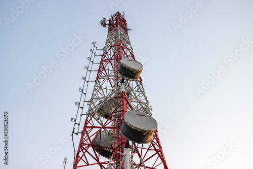 Cellular Base Station or Base Transceiver Station. Telecommunication tower. Wireless Communication Antenna Transmitter. 3G, 4G and 5G Cell Site with blue sky.