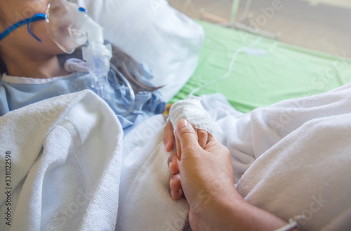 Closeup mother hand hold child patient with saline solution in hospital photo