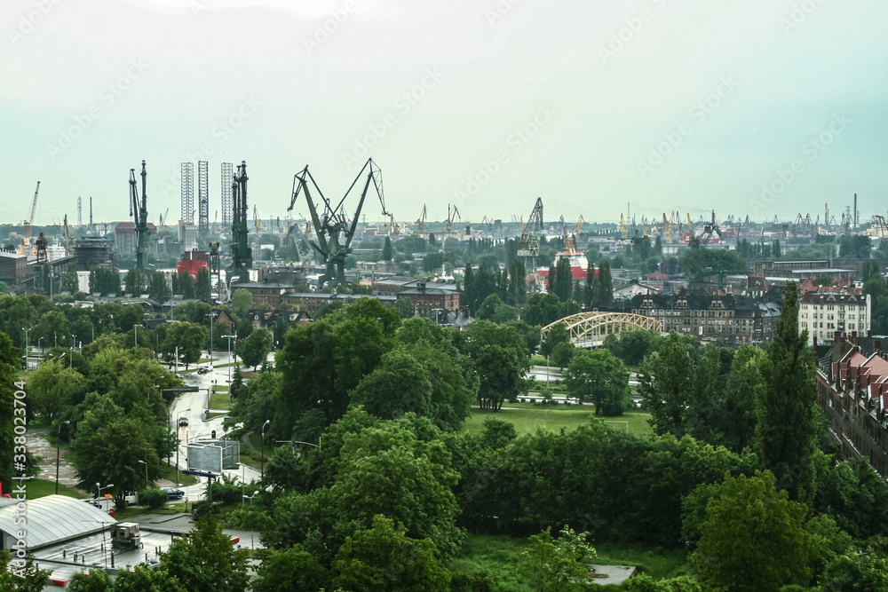 Panorama of the Gdansk shipyard with its distinctive cranes and ships being built and repaired. Also called stocznia gdanska, the shipyards are an industrial and historical landmark of Poland - obrazy, fototapety, plakaty 