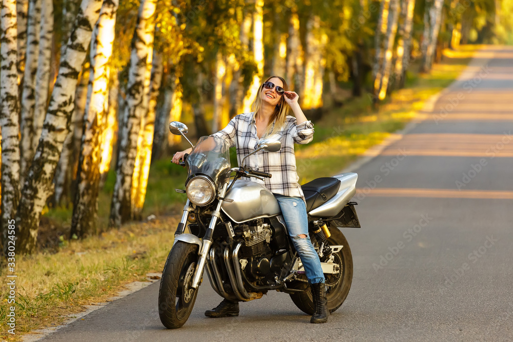 Obraz premium Sexy girl on a classic motorcycle.