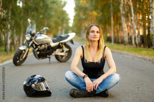 Sexy girl near a classic motorcycle © Sergey Shmakov