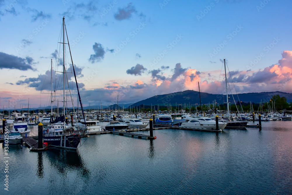 calm sea at sunset with boats