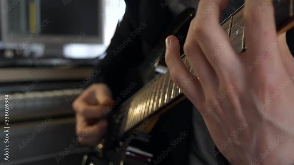 Fingers On Fretboard Strings. Close-up Hands Playing Music on Electric Guitar. Young Adult Musician Plays and Records Music at Home Studio. 2x Slow motion 0.5 speed 4K 60p Fingers On Fretboard Strings. Close-up Hands Playing Music on Electric Guitar. Young Adult Musician Plays and Records Music at Home Studio. 2x Slow motion 0.5 speed 4K 60p