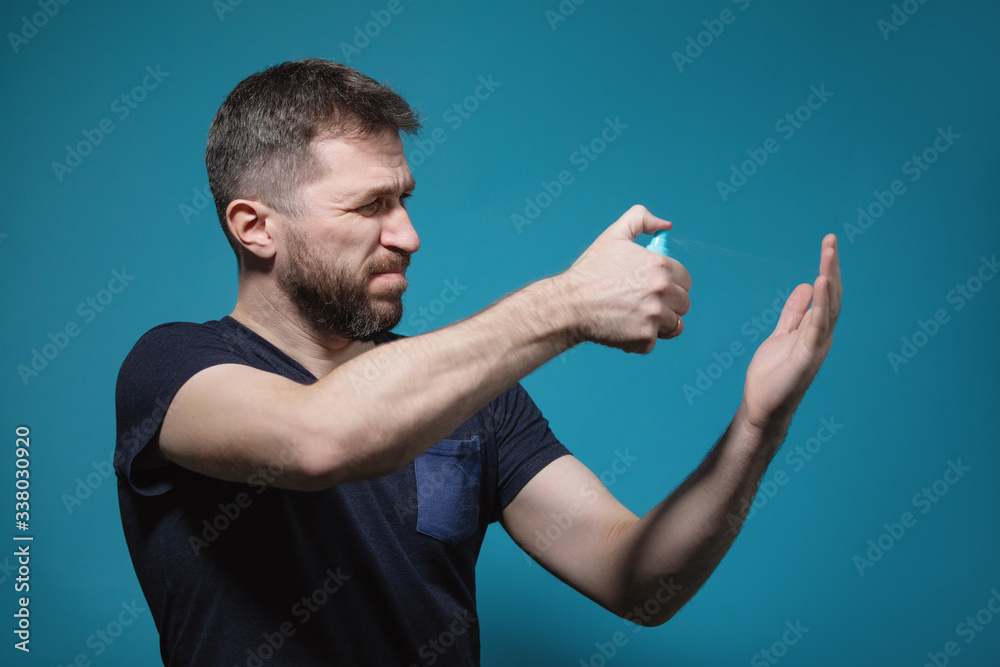Bearded man disinfects his hands. Bearded man disinfects his hands.