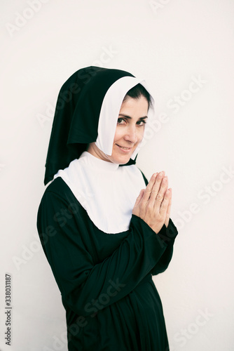 Looking at camera praying nun