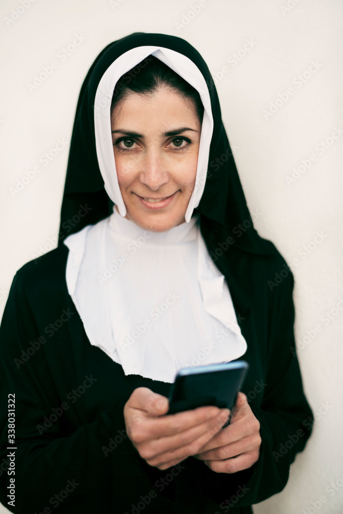 nun with smart phone on white background nun with smart phone on white background