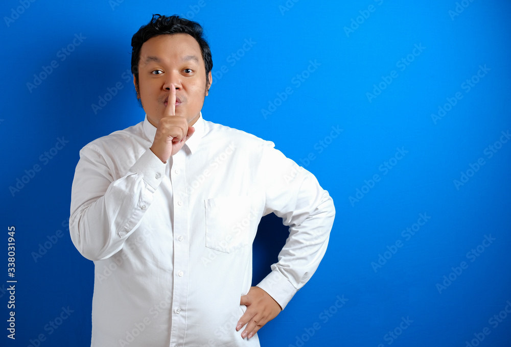 Portrait of young Asian businessman asking to be quiet Portrait of young Asian businessman asking to be quiet
