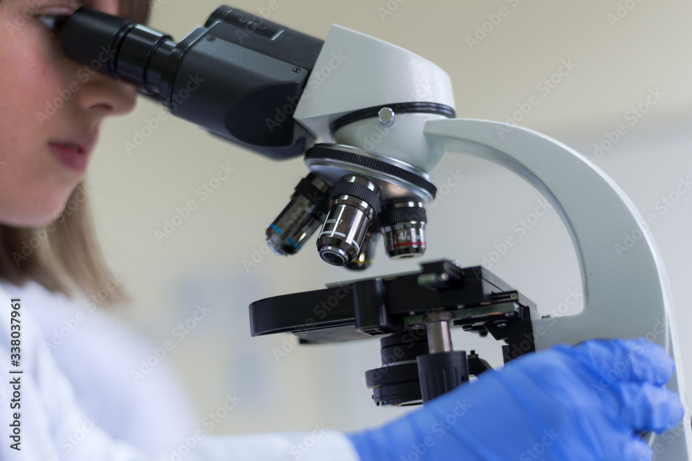 Young female Laboratory scientist working at lab with test tubes, test or research in clinical laboratory.Science, chemistry, biology, medicine and people concept. Young female Laboratory scientist working at lab with test tubes, test or research in clinical laboratory.Science, chemistry, biology, medicine and people concept.