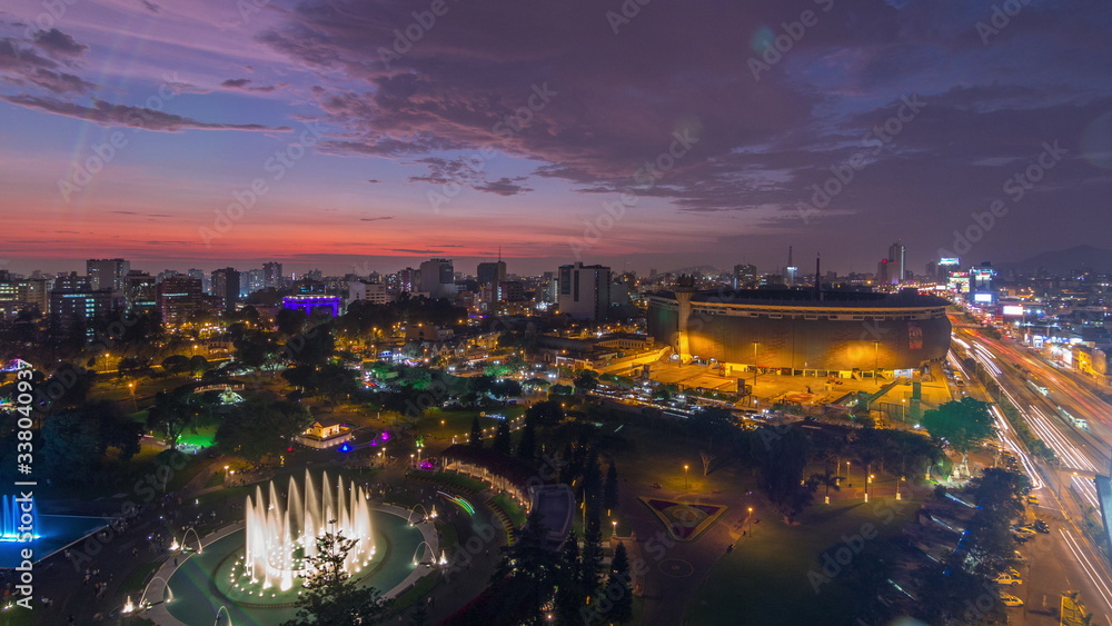 Naklejka premium Aerial view of the National stadium in the Peruvian capital Lima with Park of the Reservey day to night timelapse