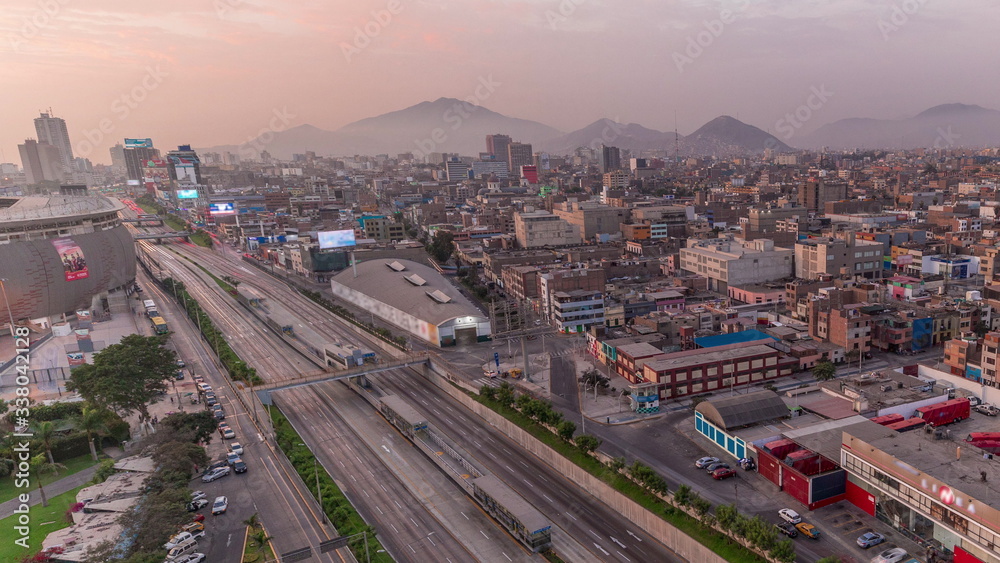 Aerial view of Via Expresa highway and metropolitan bus with traffic during sunset timelapse. Lima, Peru