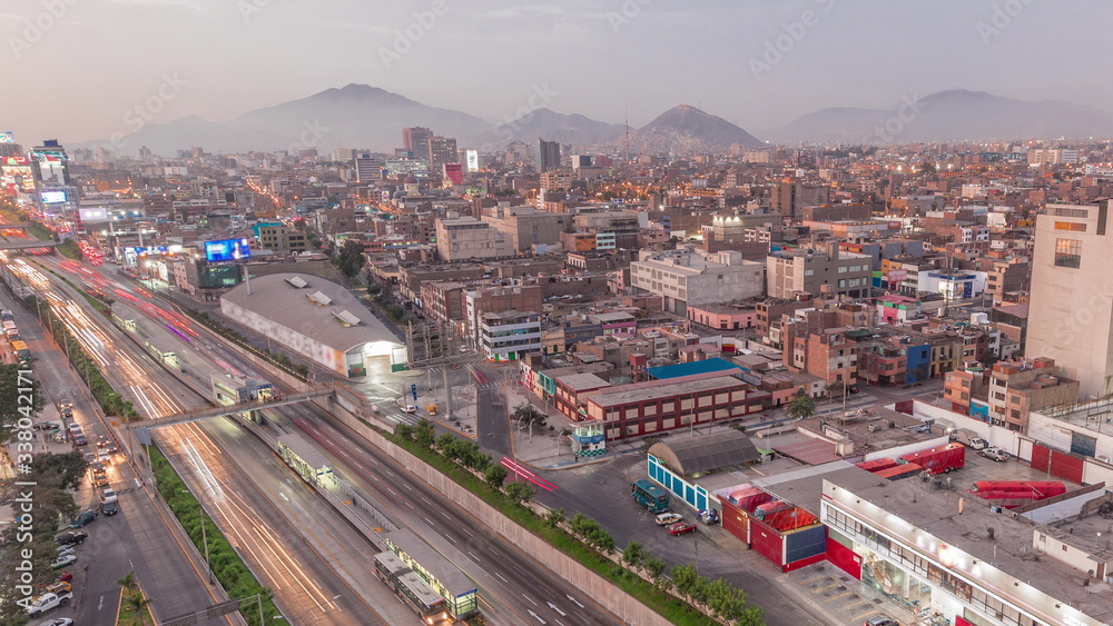 Aerial view of Via Expresa highway and metropolitan bus with traffic day to night timelapse. Lima, Peru