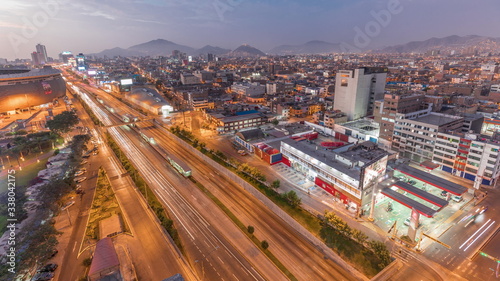Aerial view of Via Expresa highway and metropolitan bus with traffic day to night timelapse. Lima  Peru